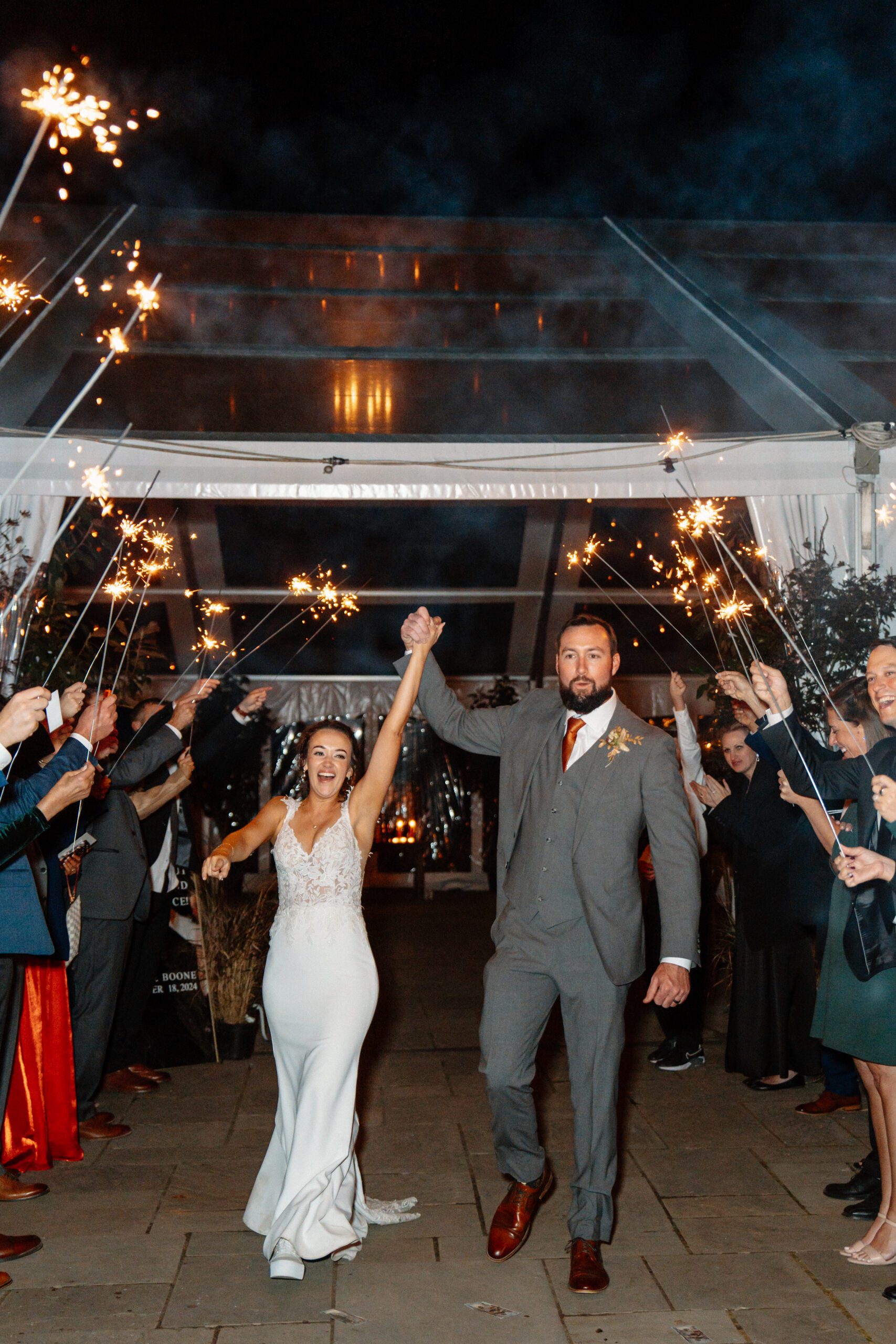 bride and groom during sparkler exit at the market at grelen fall wedding