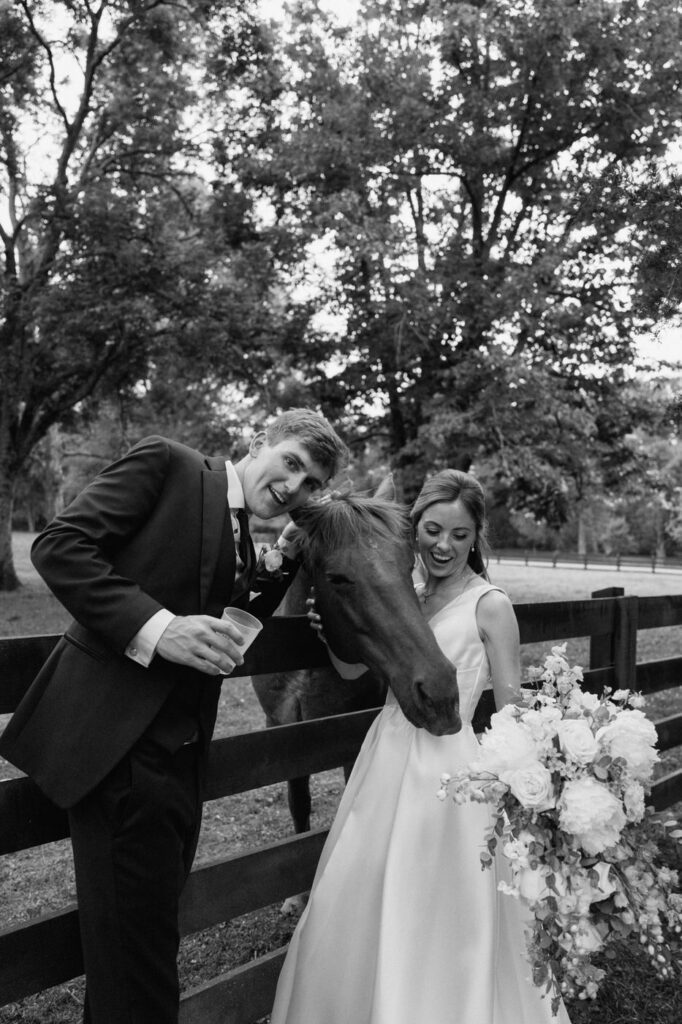 couple posing with a horse at belle meade historic site and winery