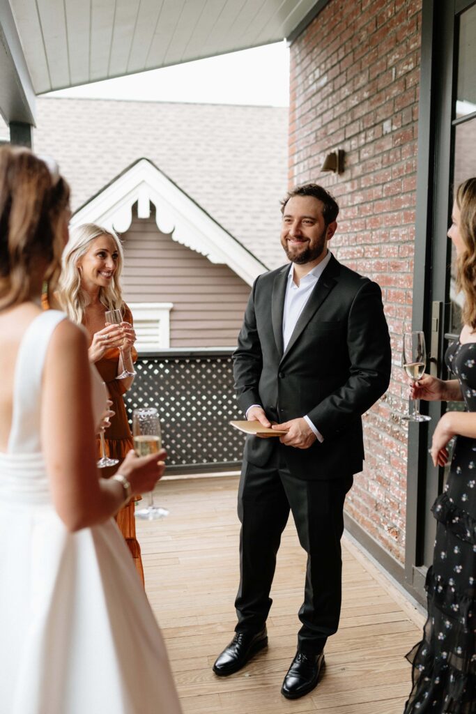 groom smiling at bride with their guests around them at nashville wedding