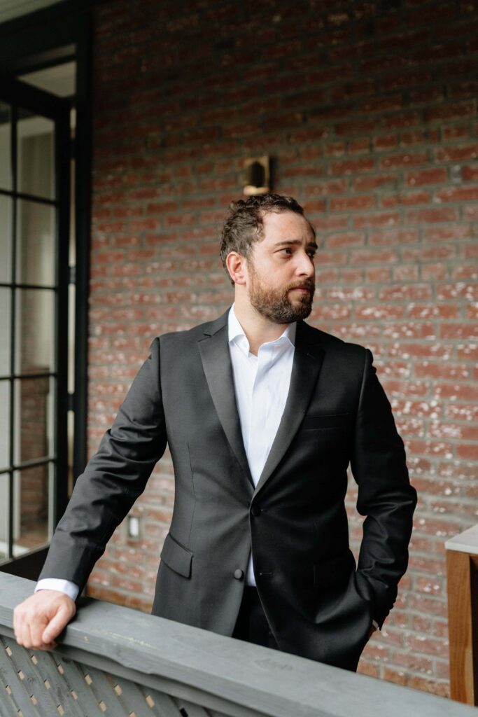 Groom standing outside in natural lighting in nashville
