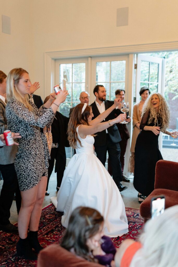 Evening candid moment of the bride dancing inside the venue