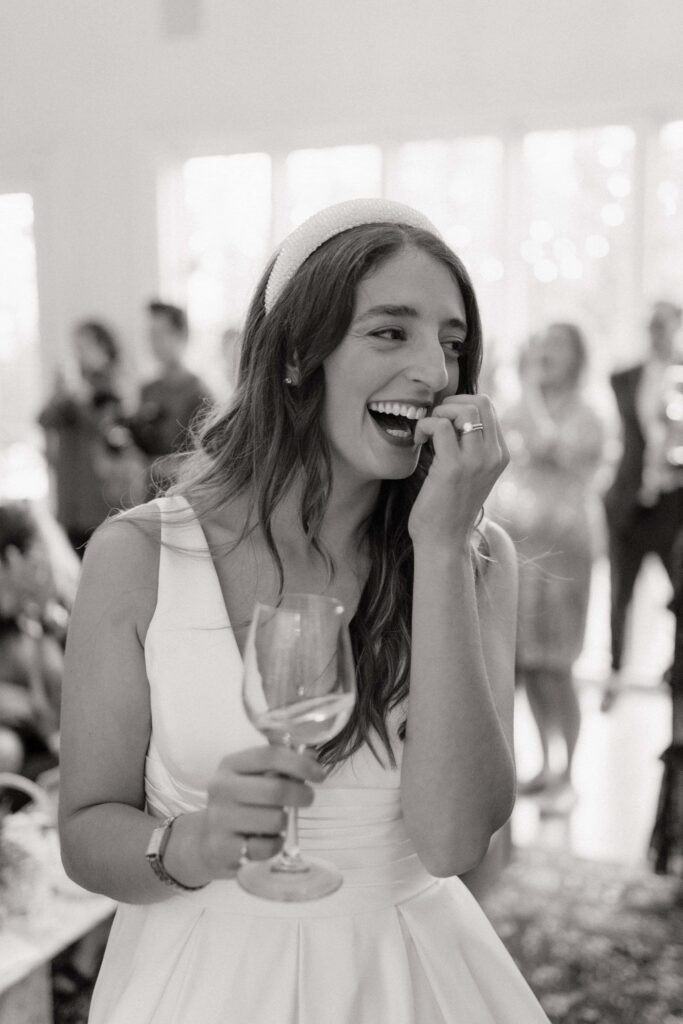 bride laughing candidly during speeches
