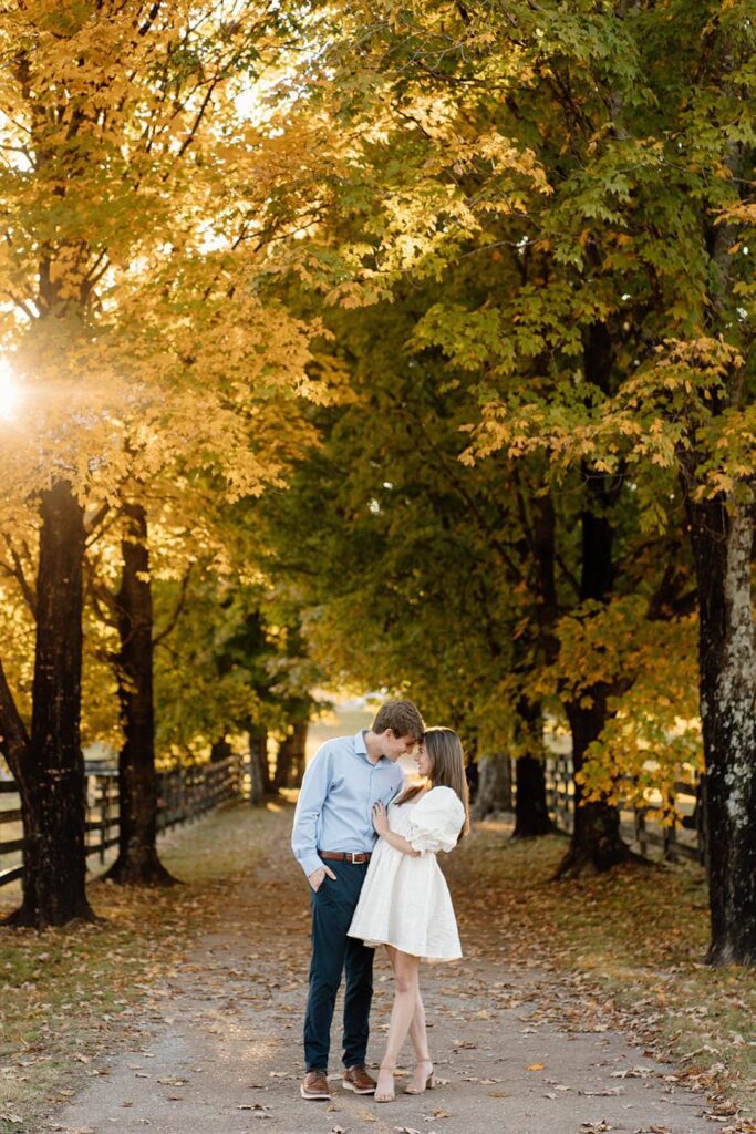 Couple walking through golden hour light during engagement photos