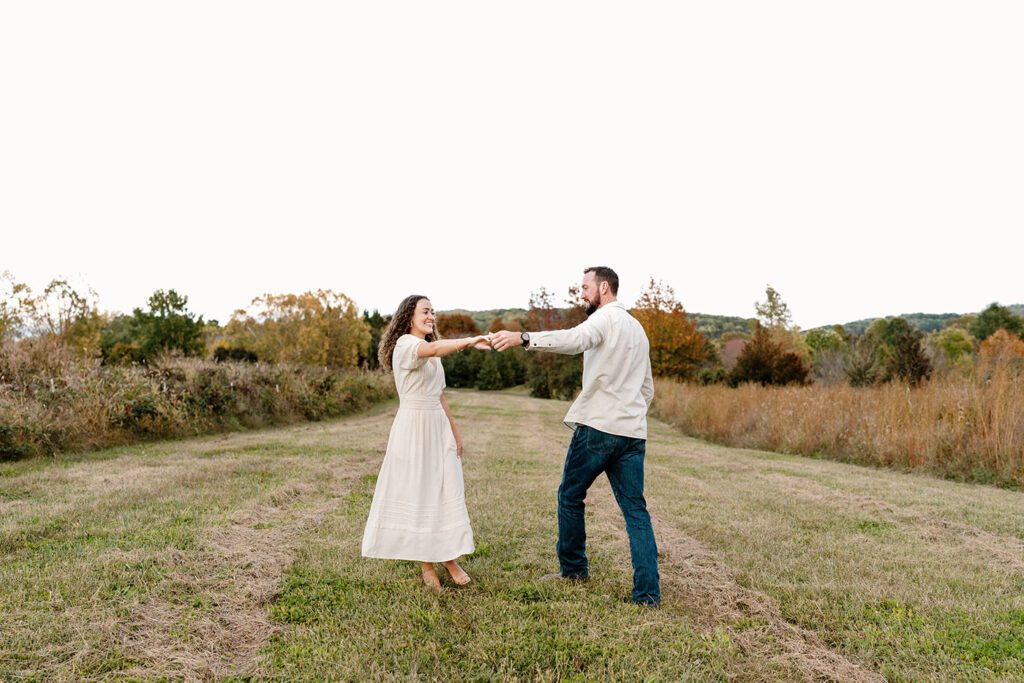 Couple walking hand in hand along a nature trail in Charlottesville, Virginia