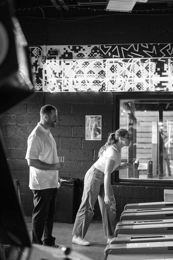 Couple playing skeeball in Nashville during engagement session
