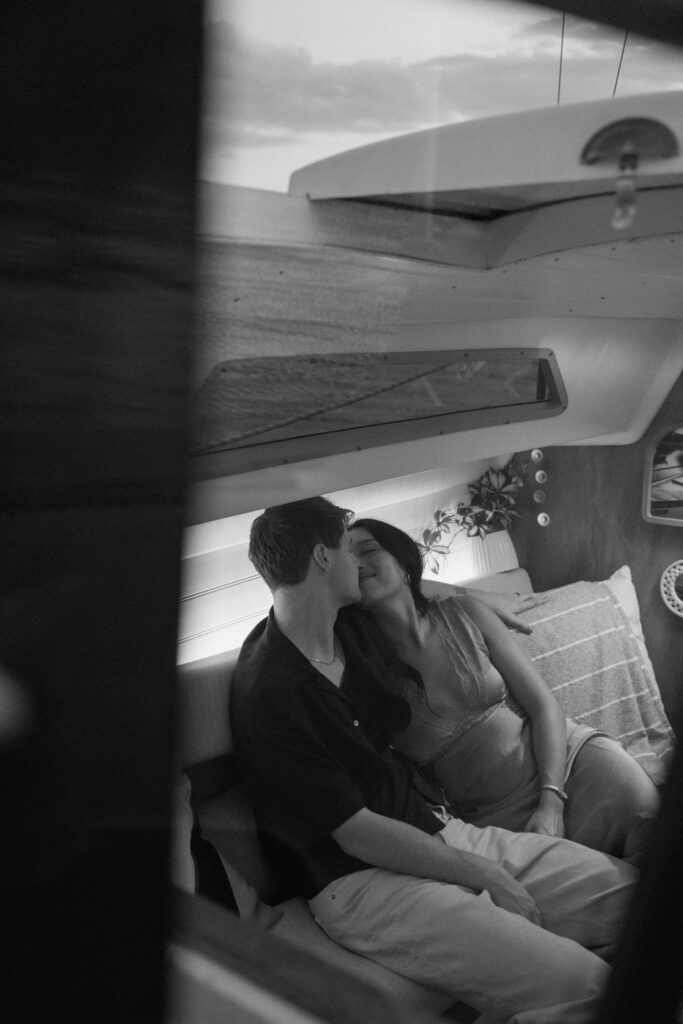 Couple sharing a romantic moment inside the sailboat in Nashville