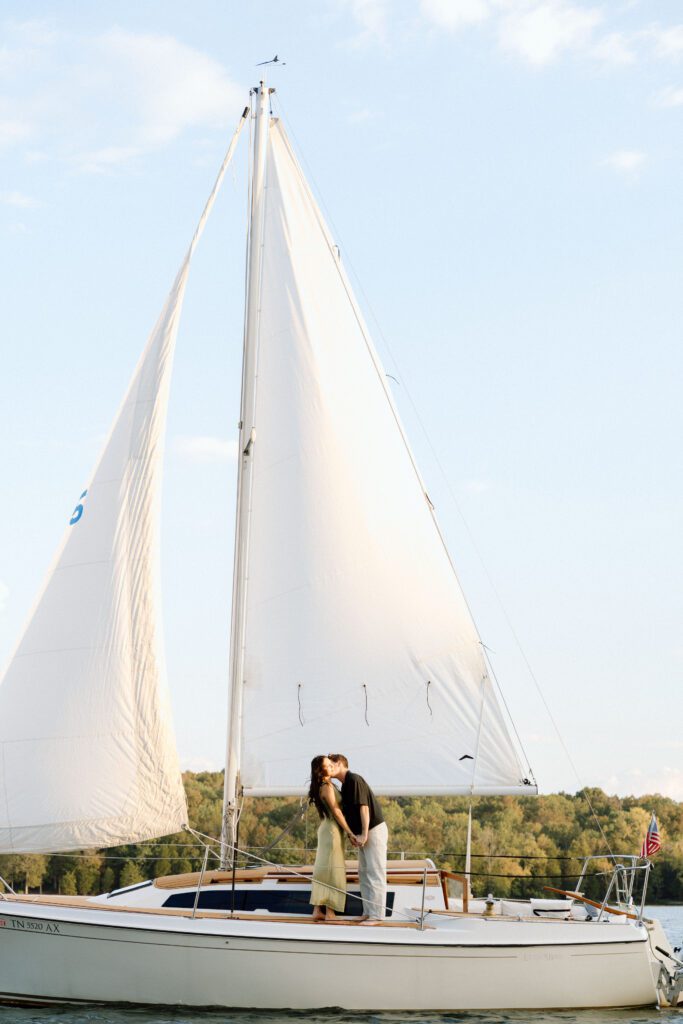Wide shot of the sailboat with soft sunset light on Percy Priest