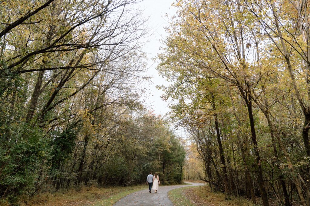 Couple walking through Shelby Bottoms Park during their Nashville engagement session