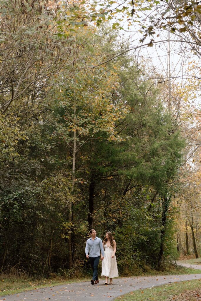 Candid walking shot during their Shelby Bottoms Park engagement session