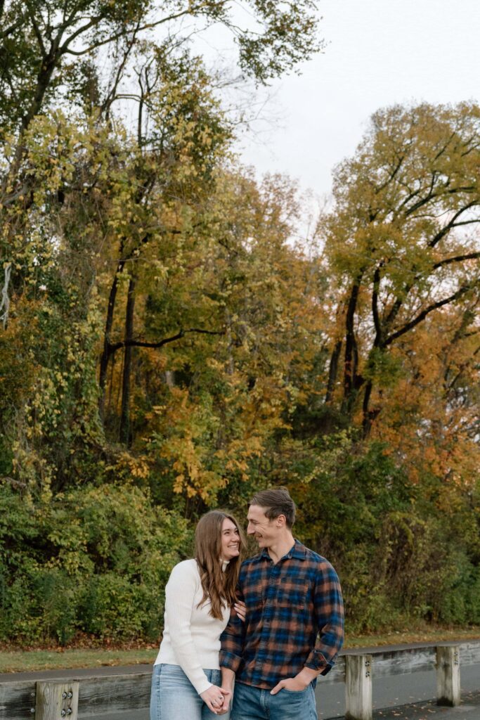 Engagement photo with the tree line and warm sunset light at Shelby Bottoms