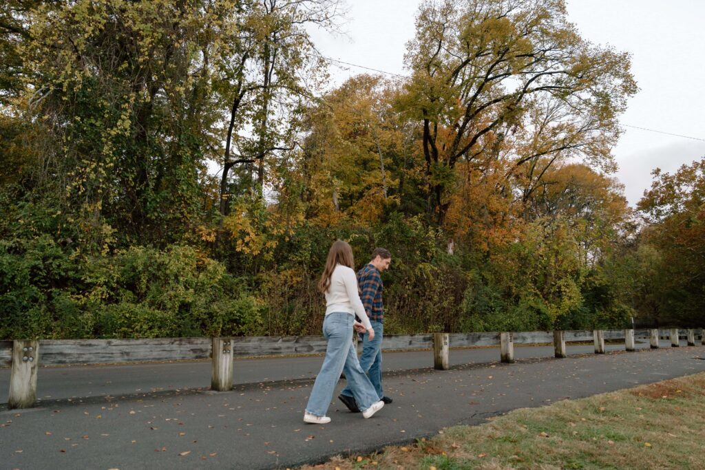 Movement shot of the couple walking near the tree line at Shelby Bottoms