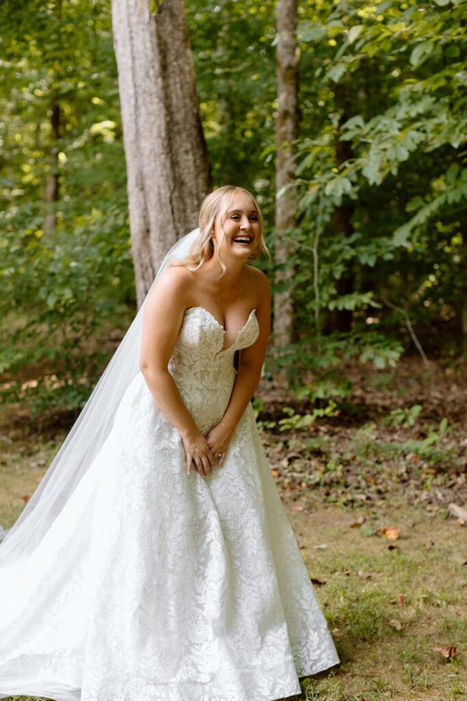 bride laughing seeing her dad during their first look