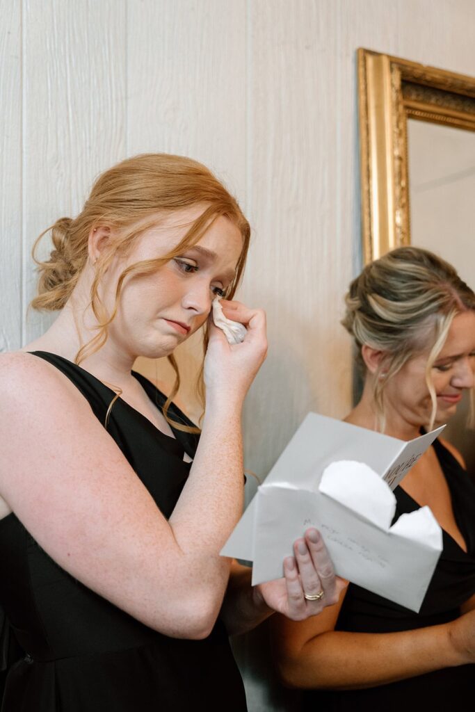 bridesmaid getting emotional reading a letter from the groom on wedding day