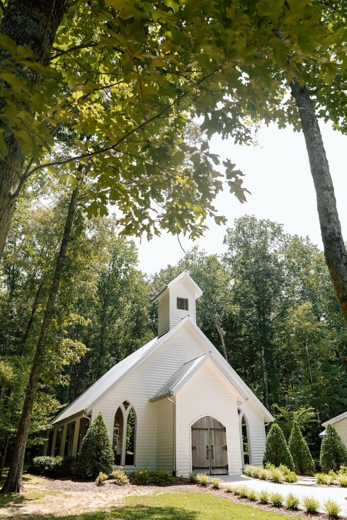 the chapel at firefly lane framed by trees during the summer