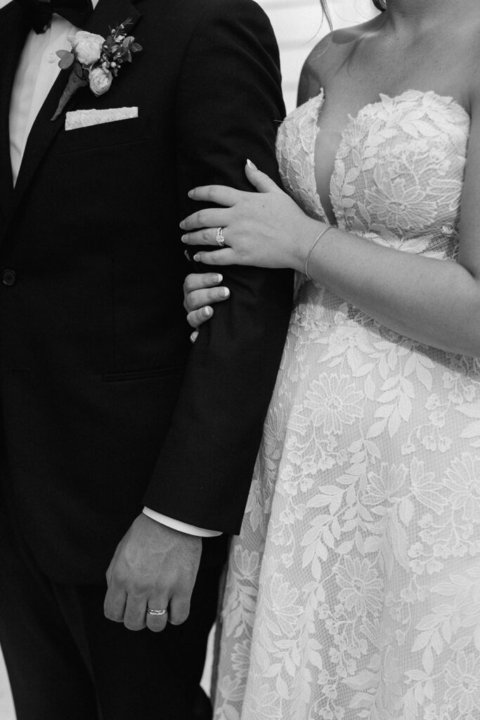 Close up of couples hands and attire on wedding day