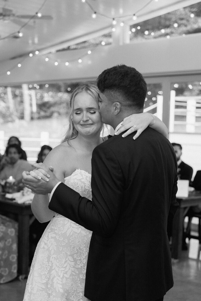 Couple getting emotional during their first dance at wedding reception