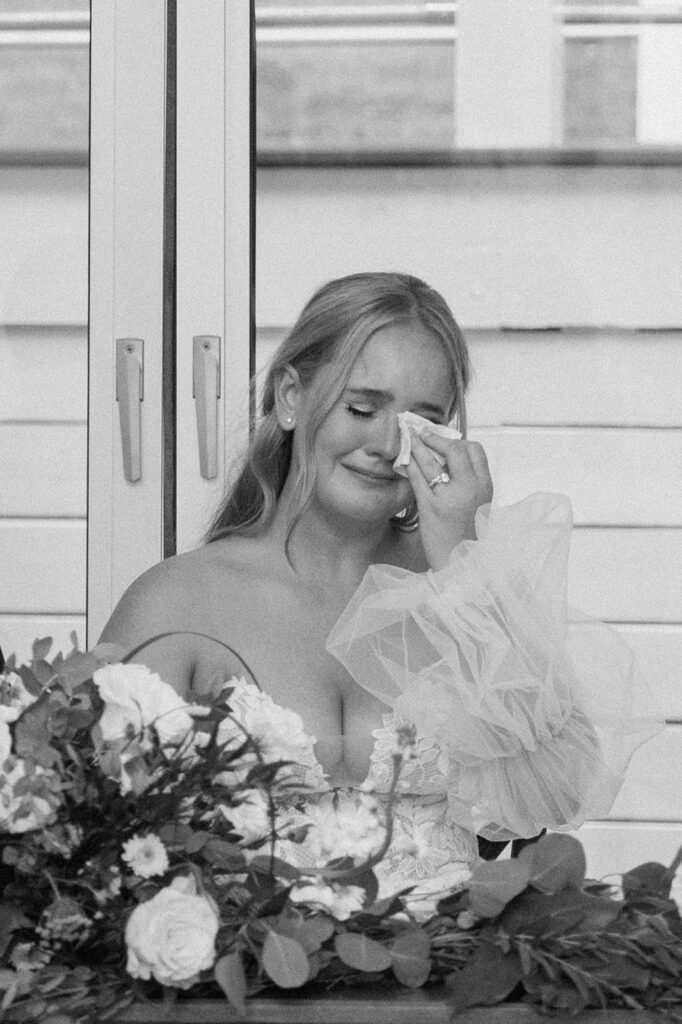 Bride wiping away tears during reception speeches at the Chapel at Firefly Lane