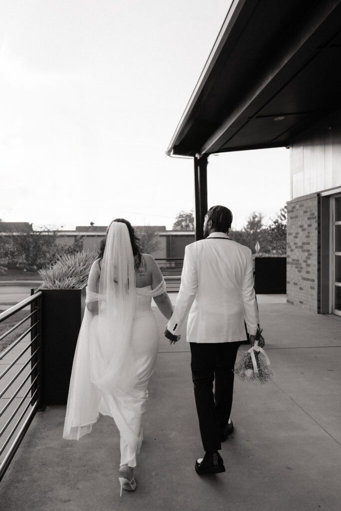 couple walking and holding hands at 14tenn in nashville tennessee