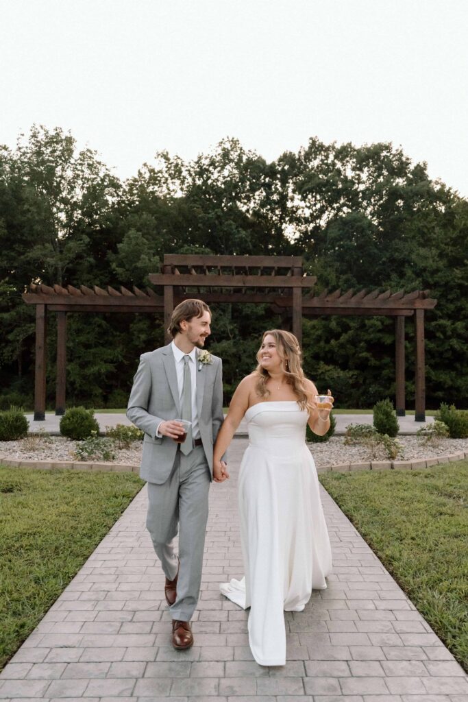 couple holding hands and walking outside the venue at fiddle dee farms near nashville