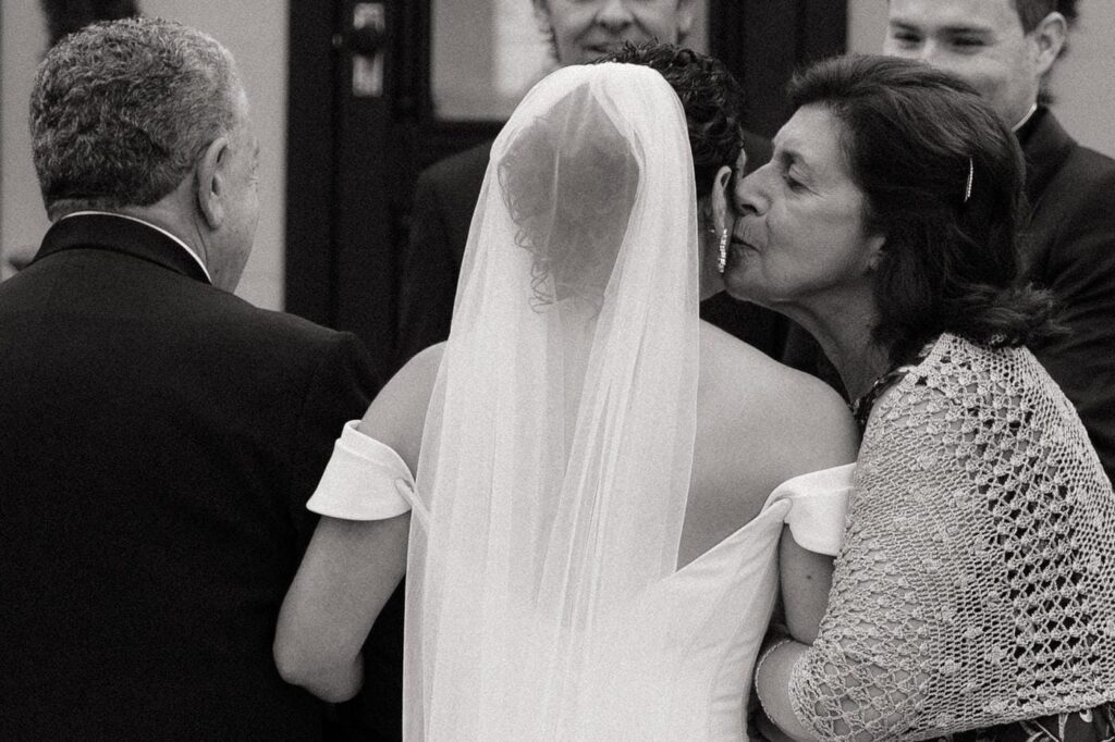 mother of the bride kissing her on the cheek as she hands her off at estelle wedding venue in east nashville