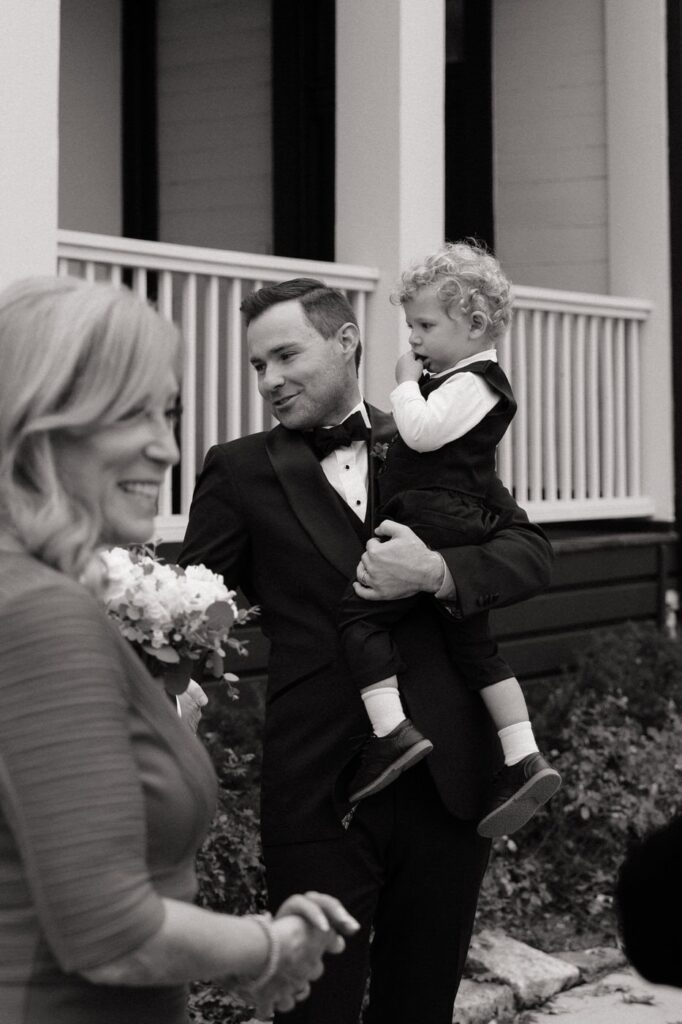groom talking with family at wedding in east nashville