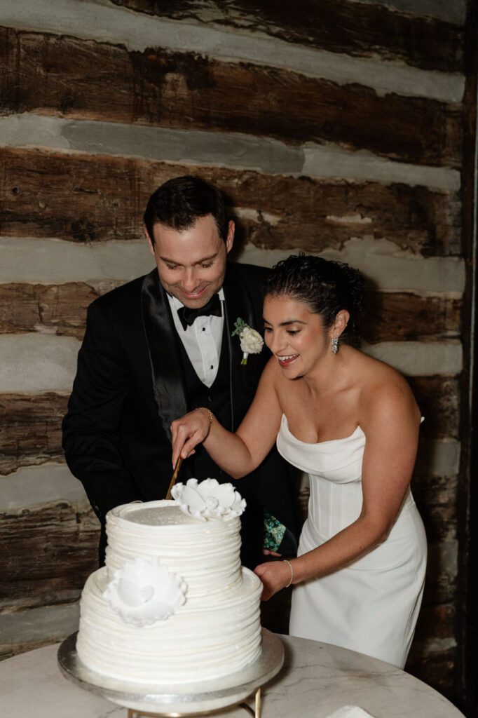 couple cutting their cake at east nashville wedding venue