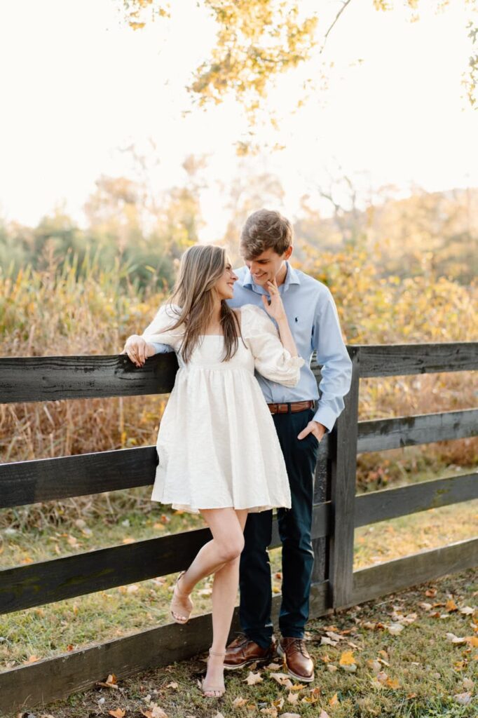 couple smiling at each other during engagement session in nashville