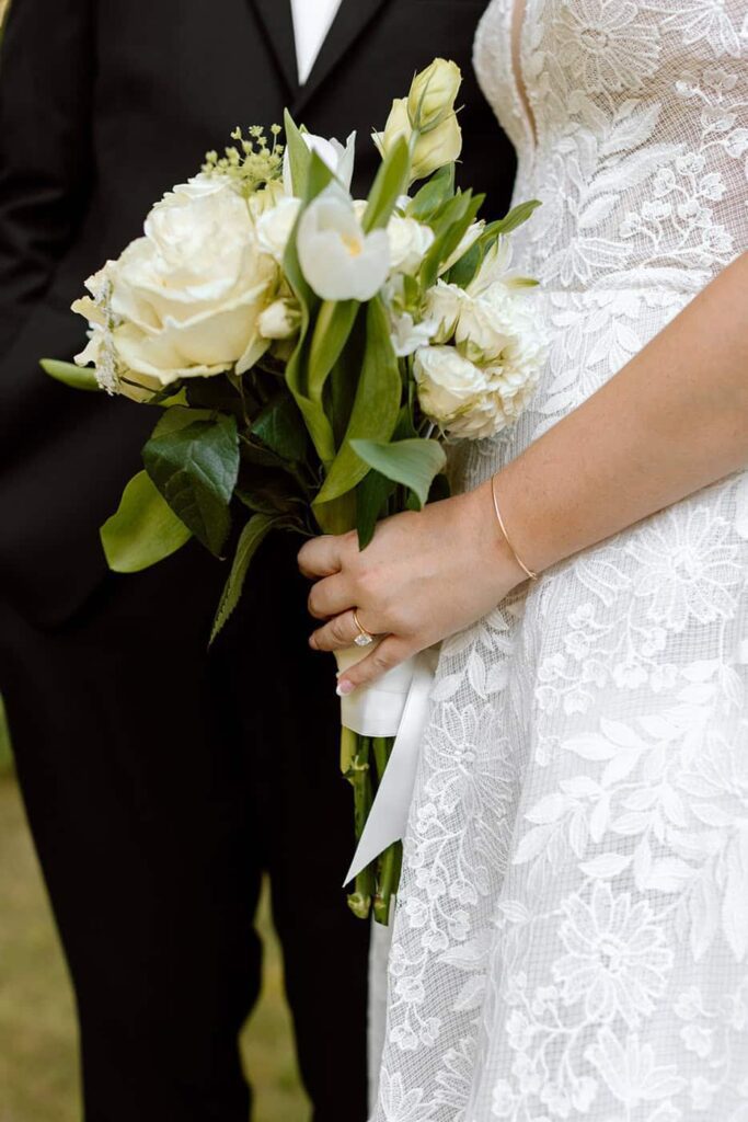 close up shot of bride and groom and the bouquet on wedding day