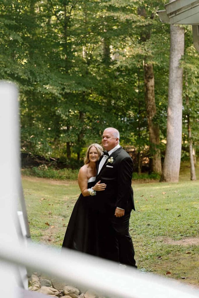 brides parents watching the couples first look on their wedding day