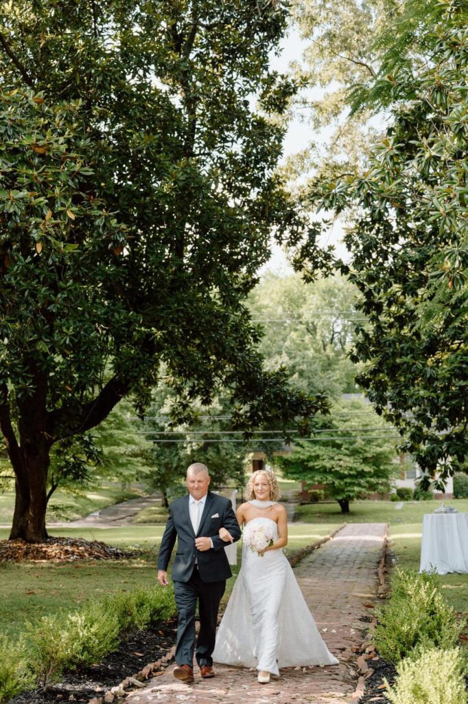 bride and her father walking down the aisle at wedding venue in west tennessee
