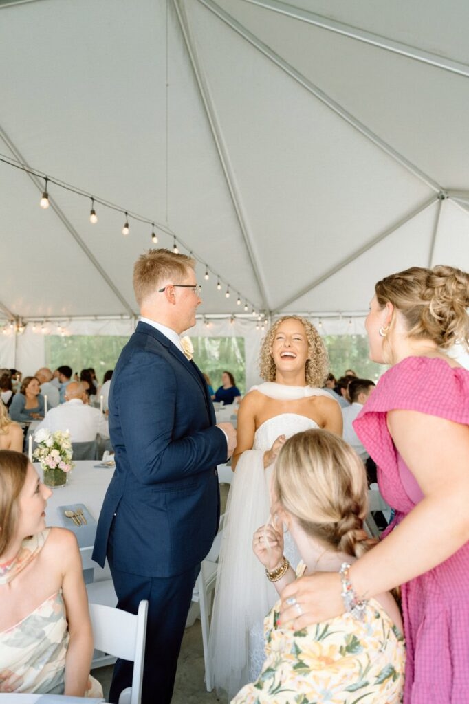 bride and groom candidly laughing with wedding guests at tennessee wedding venue