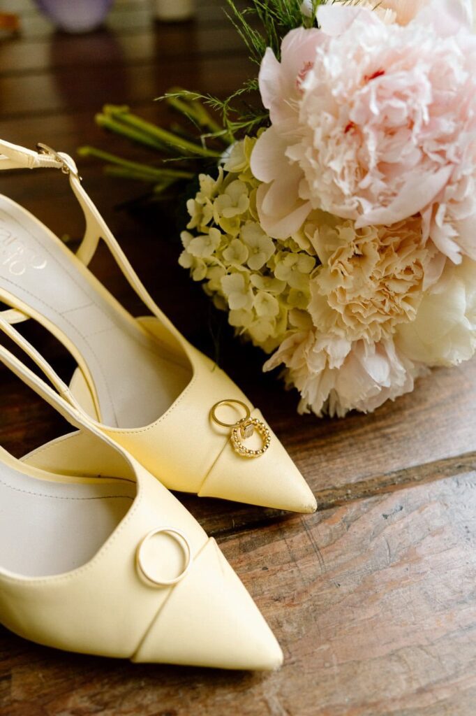 close up shot of rings, shoes, and florals at nashville wedding