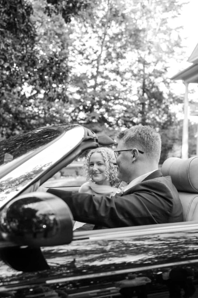 bride and groom sitting in getaway car in tennessee on their wedding day
