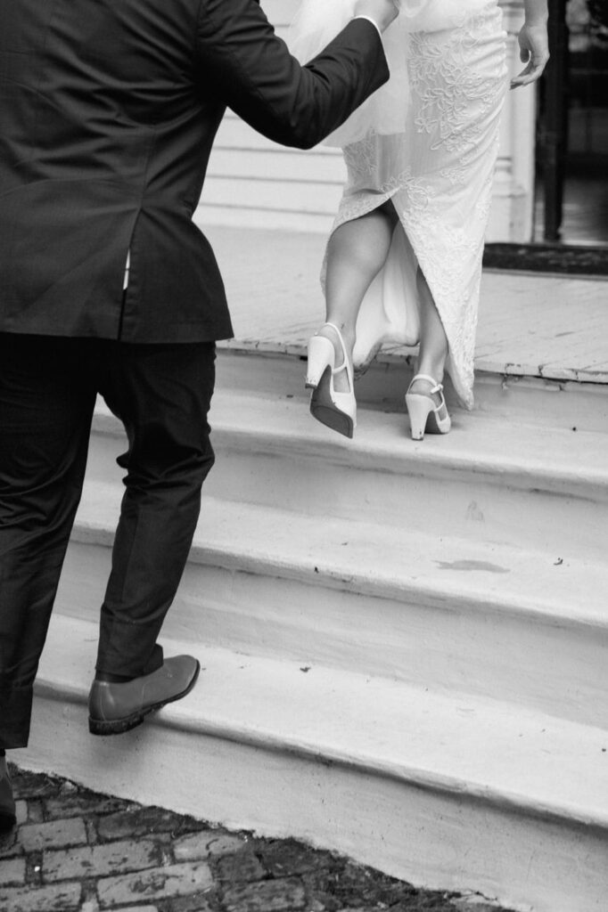 groom and bride walking up steps of eader house venue in tennessee