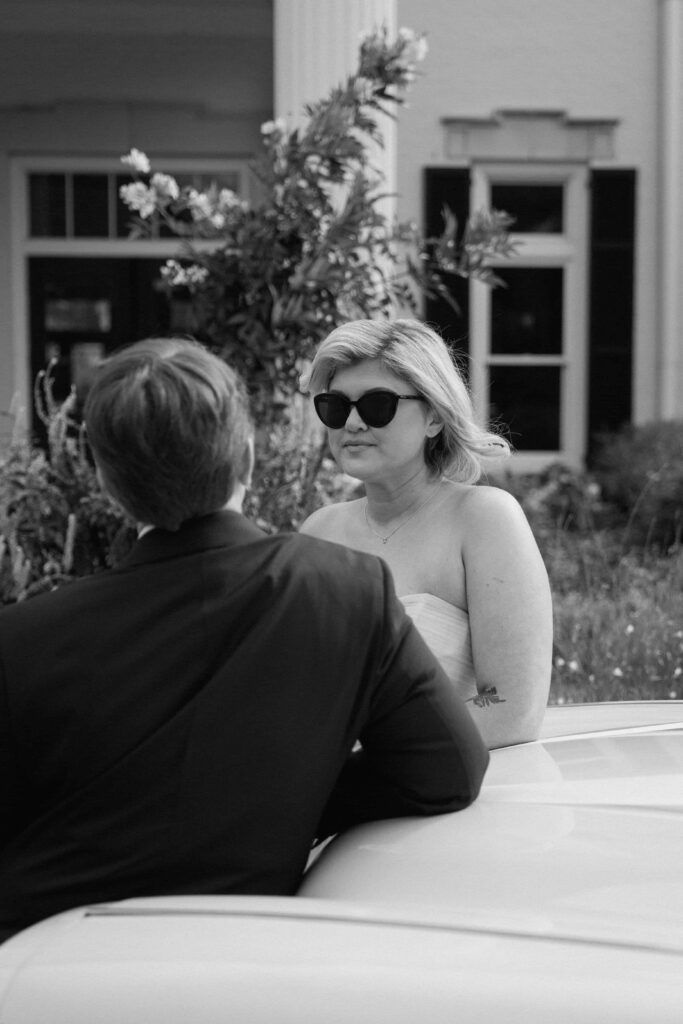 couple looking at each other outside of huntsville botanical garden