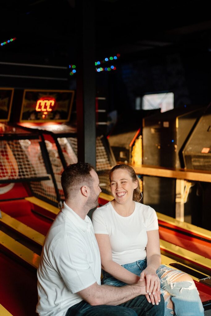 couple laughing at updown during engagement session in nashville