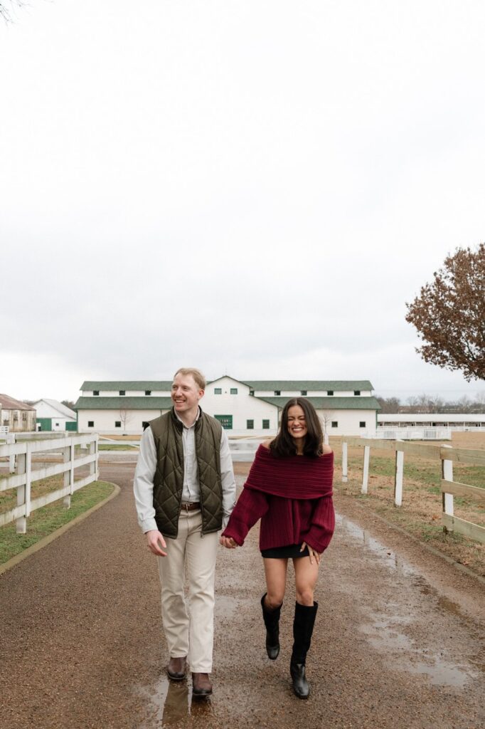 couple walking along the driveway at harlinsdale farm in franklin tennessee