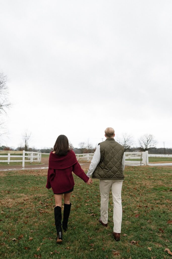 couple holding hands and walking at harlinsdale farm