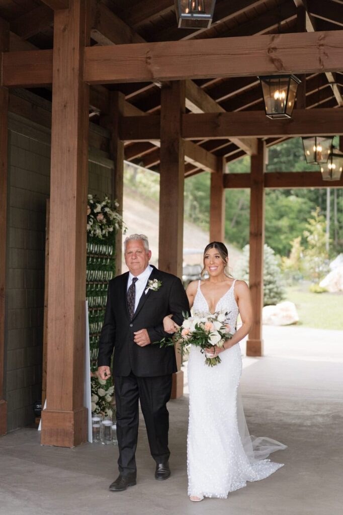 bride and father walking down the aisle at gatlinburg wedding in the mountains