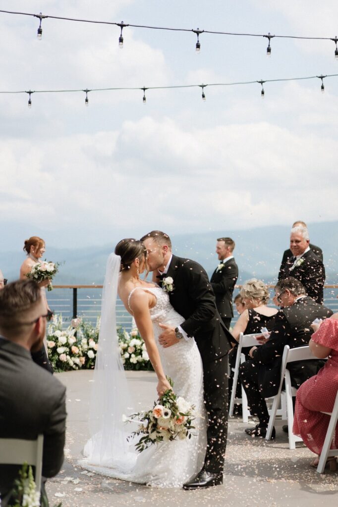 couple kissing after walking back down the aisle at gatlinburg wedding venue