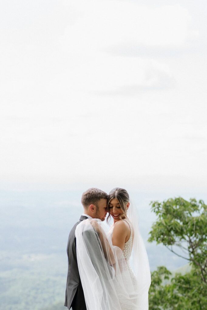 sweet moment between a couple overlooking the mountains in gatlinburg