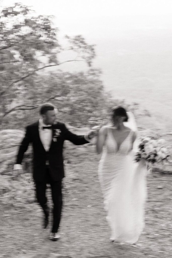 couple running along the mountains in gatlinburg on wedding day