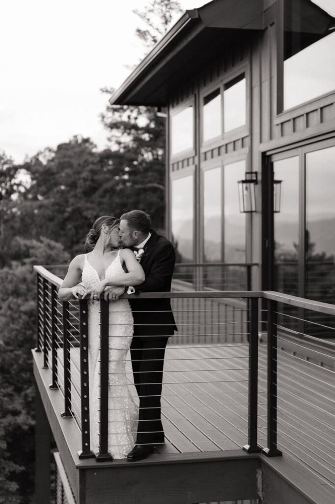 couple kissing on the balcony at trillium in the smoky mountains