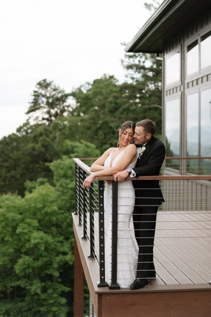 couple standing on the balcony at trillium venue in the great smoky mountains on their wedding day
