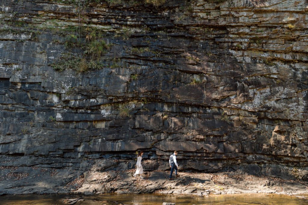 wide shot of couple hiking at fall creek falls elopement in the fall