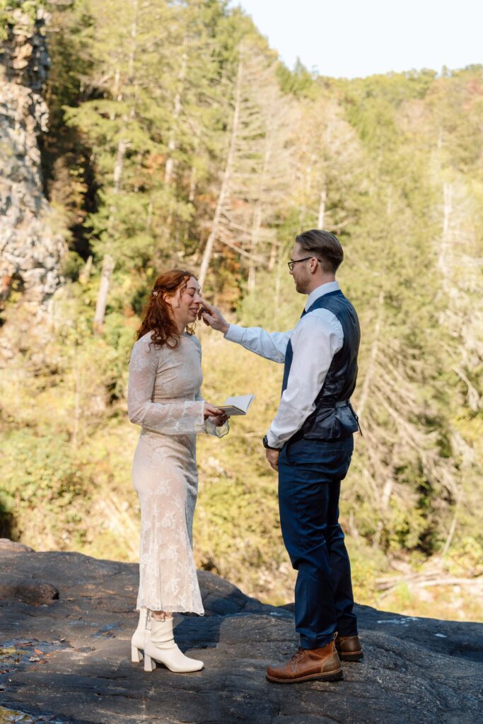 groom wiping a tear from bride's face at tennessee elopement