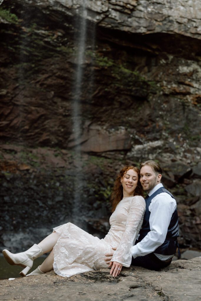 couple sitting on the rock during their elopement in tennessee