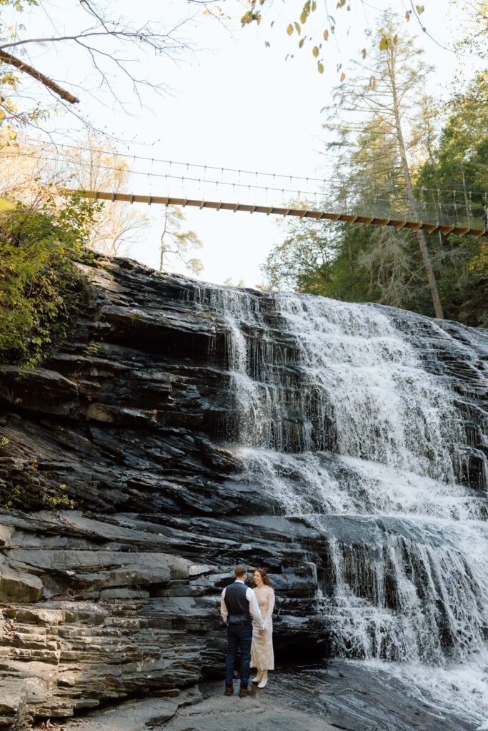 couple standing in front of the waterfalls at fall creek falls elopement