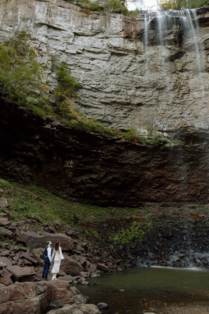 couple admiring the waterfall at their tennessee elopement