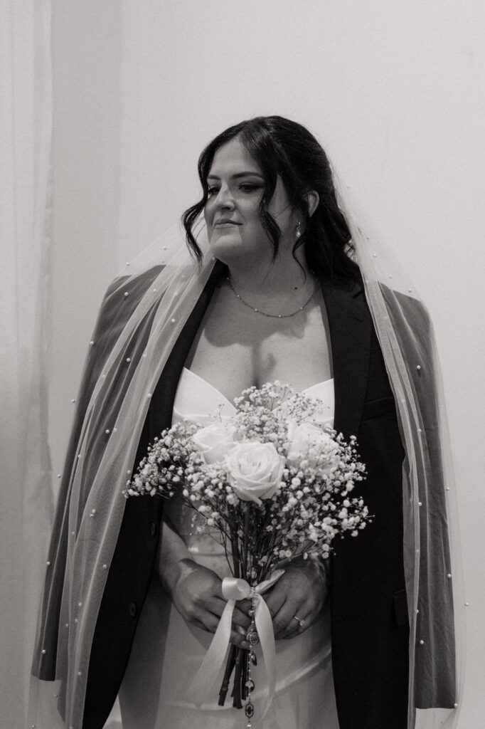 bride wearing her fathers jacket before going down the aisle